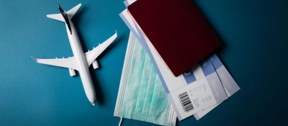 Travel,During,The,Covid-19,Pandemic.,Airplane,Model,With,Face,Mask